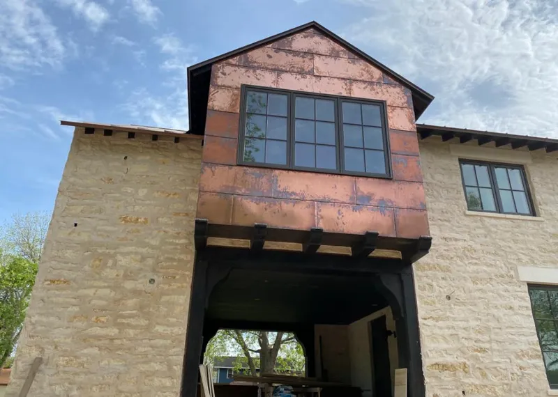 Copper metal panel facade on a stone building for Roof Repair in Prescott